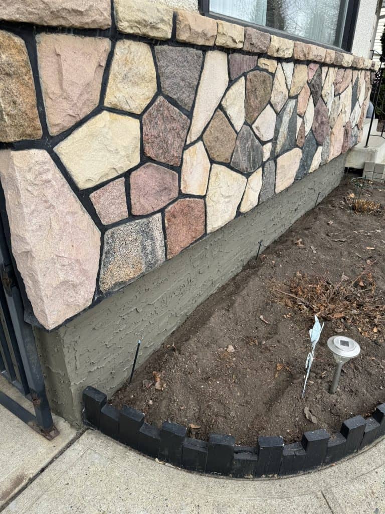 Finished foundation parging on a St. Albert home by J and J Coatings