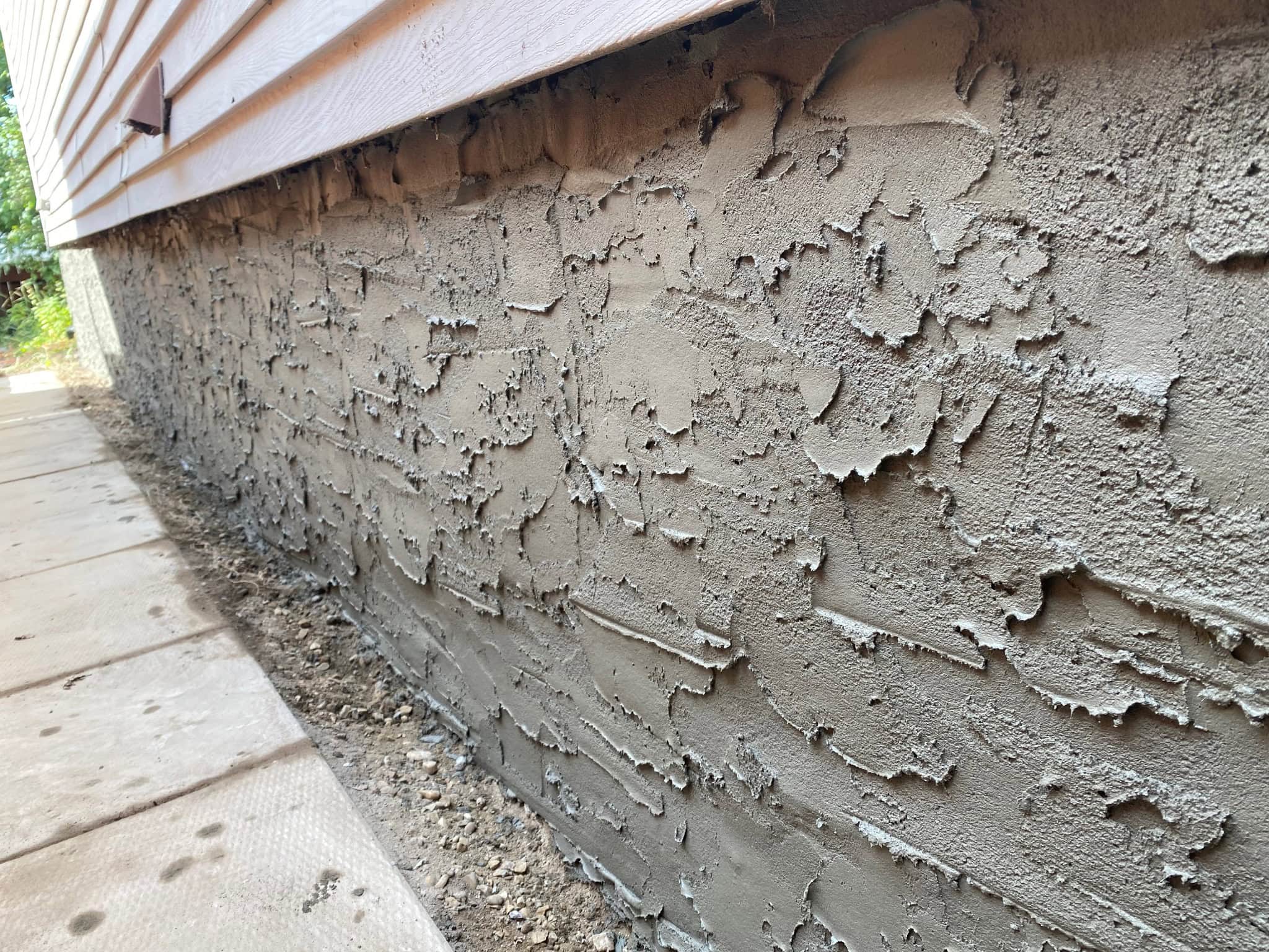 Close-up of finished cementitious foundation parging texture