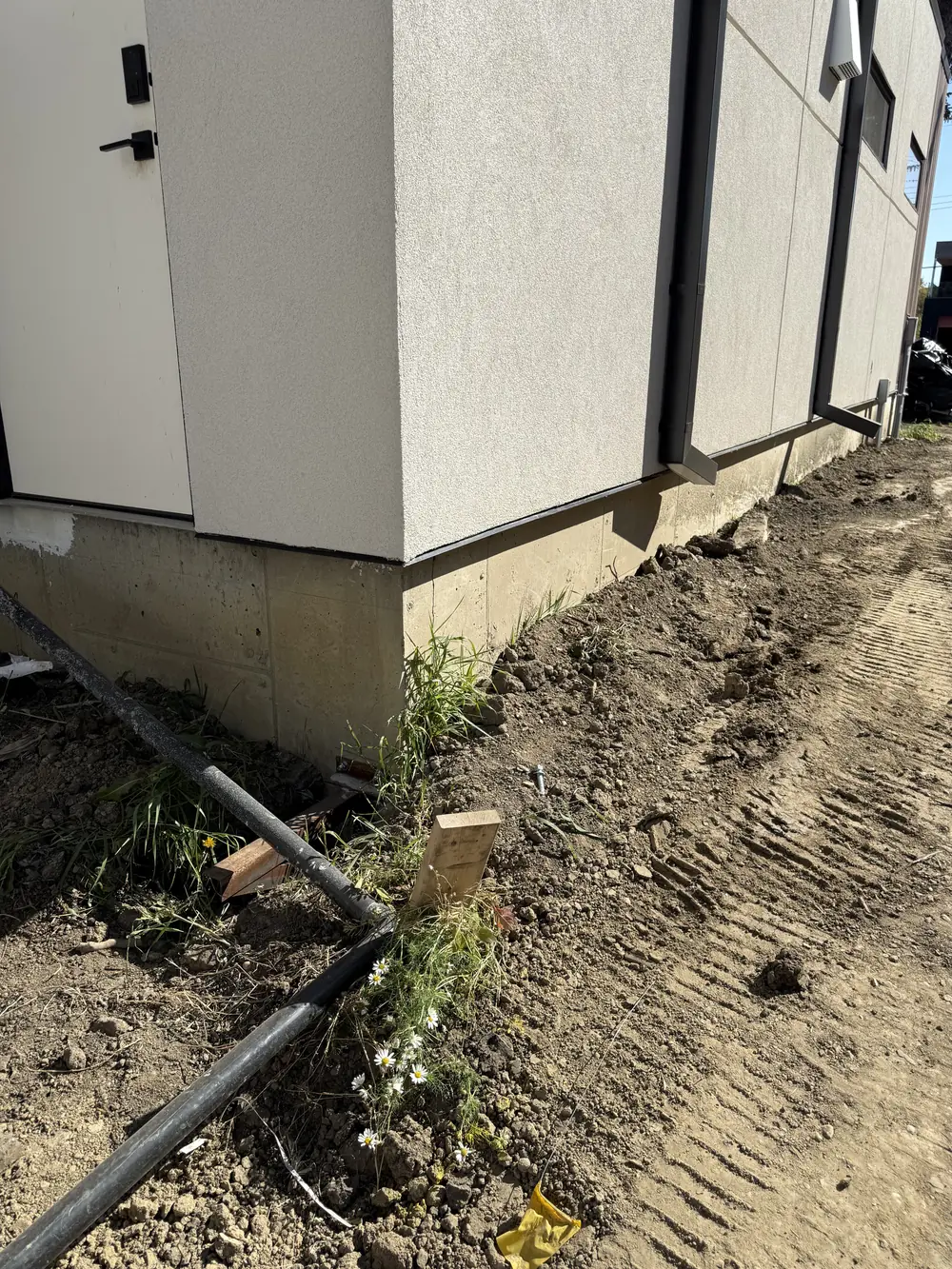 Exposed concrete foundation at a corner before coating