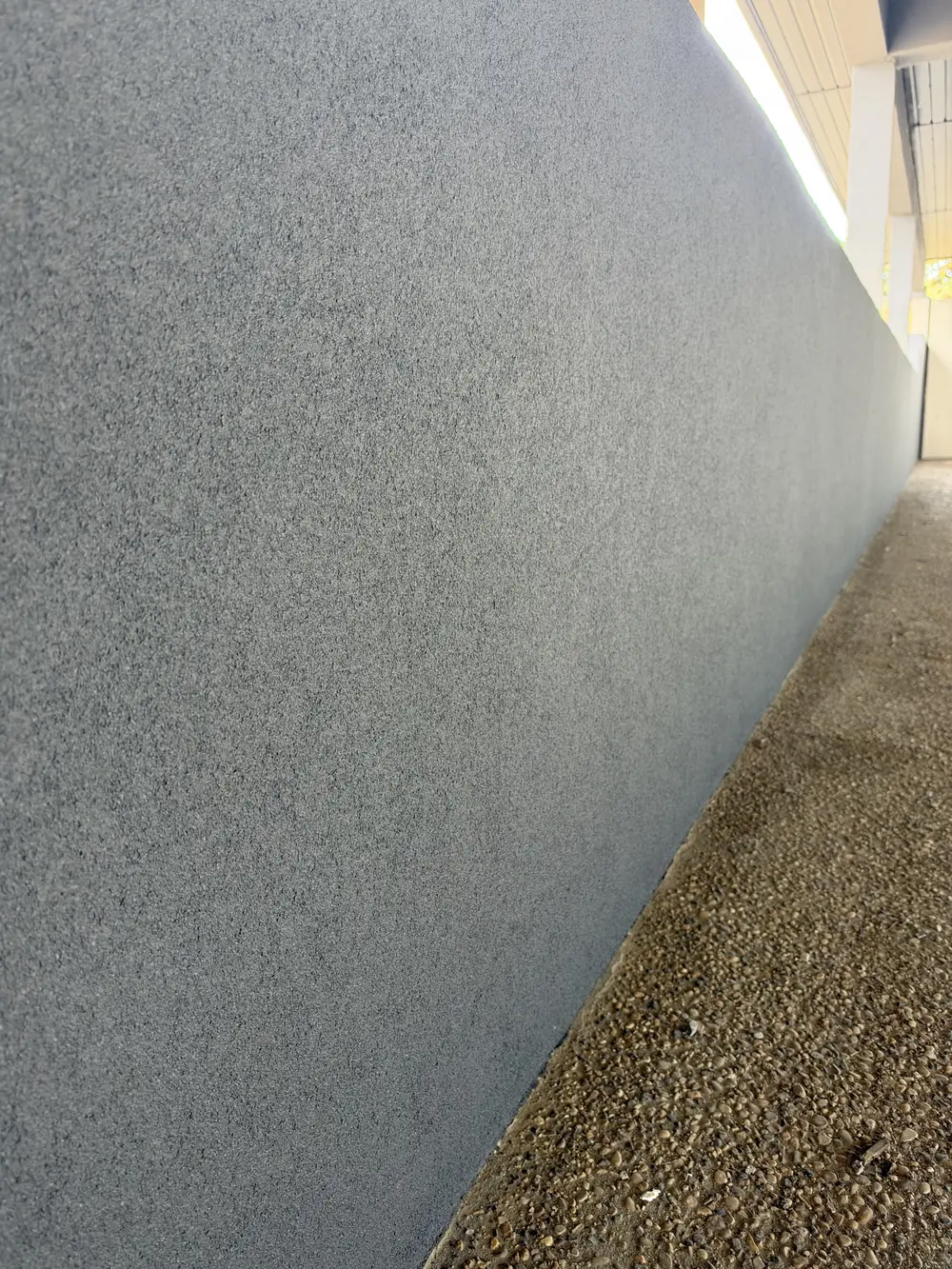 Close view of the grey textured acrylic finish on a wall